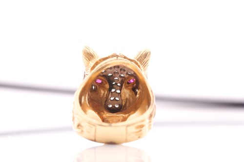 Lot 75 - A diamond and ruby set panther mask ring; the...