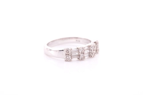 Lot 199 - A diamond half hoop ring; comprising two rows...