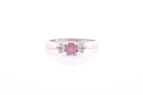 Lot 83 - A pink sapphire and diamond three stone half...