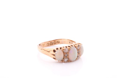 Lot 8 - An Edwardian opal and diamond ring; the three...