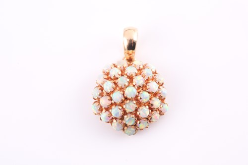 Lot 9 - An opal cluster pendant, the circular bombé...