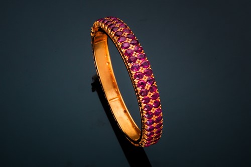 Lot 20 - A ruby bangle; composed of two rows of mixed...