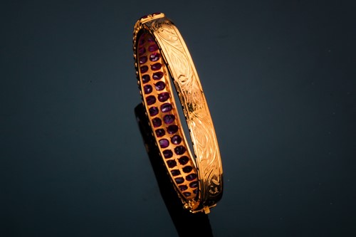 Lot 20 - A ruby bangle; composed of two rows of mixed...