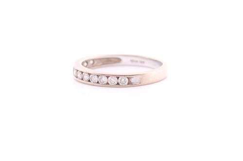 Lot 136 - A twelve stone half hoop diamond eternity ring;...
