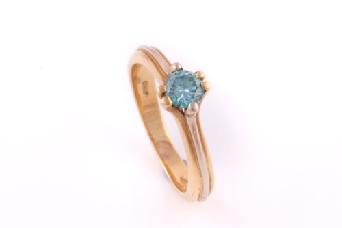 Lot 89 - A single stone blue diamond ring; the round...