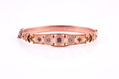 Lot 151 - An Edwardian 9 carat rose gold, ruby, and...