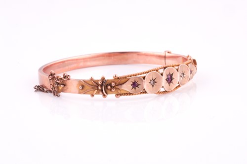 Lot 151 - An Edwardian 9 carat rose gold, ruby, and...