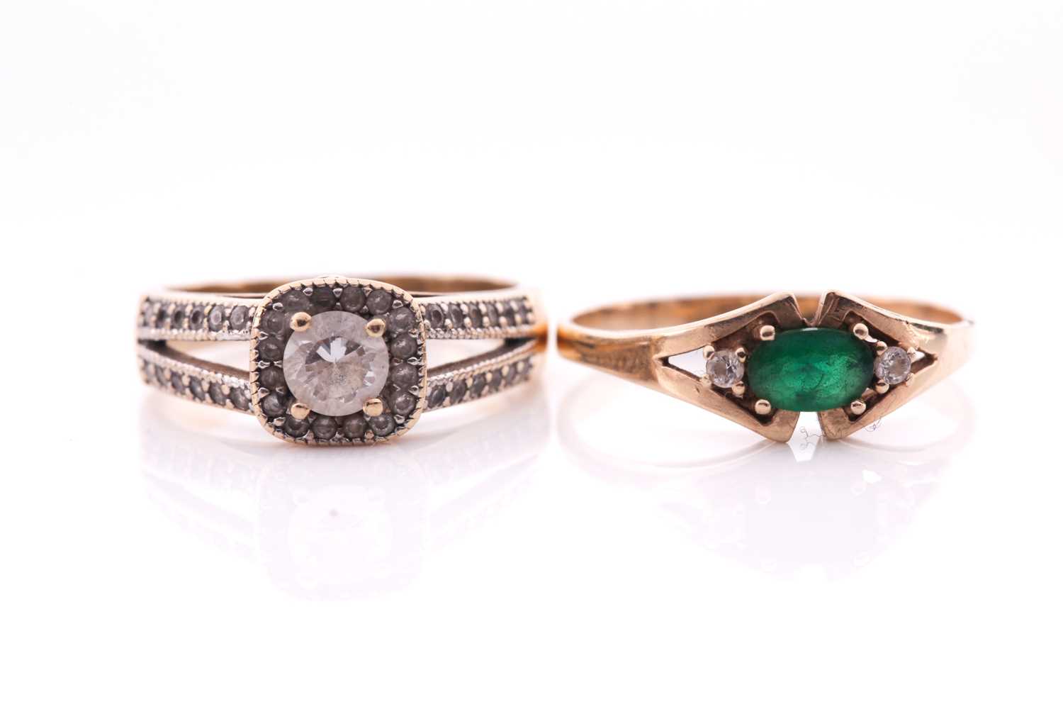 Lot 258 - An emerald and diamond three stone half hoop...