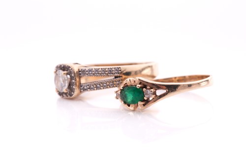 Lot 258 - An emerald and diamond three stone half hoop...