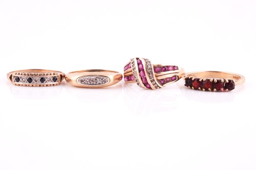 Lot 187 - A ruby and diamond cross-over dress ring in 9...