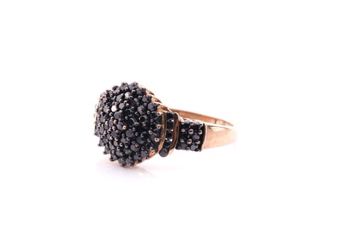 Lot 42 - A black diamond cluster ring; the bombé style...