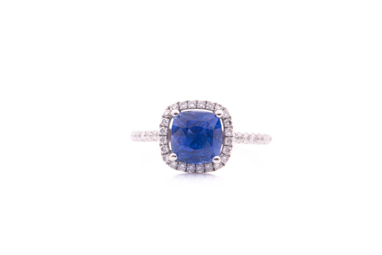 Lot 62 - A sapphire and diamond cluster ring; the...