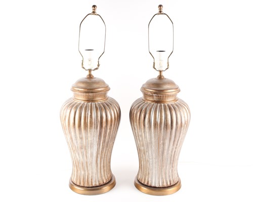 Lot 193 - A pair of gilt pottery table lamps of bold...