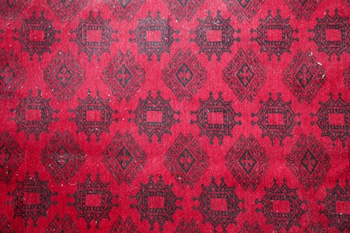 Lot 178 - A 20th-century madder red ground Afghan carpet,...
