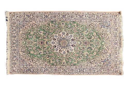 Lot 107 - A 20th-century pistachio green ground Nain rug....