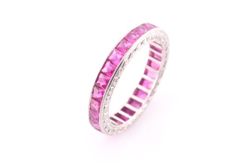 Lot 151 - A ruby eternity ring, set with mixed faceted...