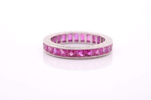 Lot 151 - A ruby eternity ring, set with mixed faceted...