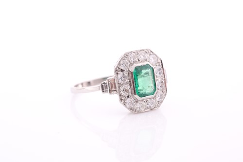 Lot 17 - A platinum, diamond, and emerald ring, set...