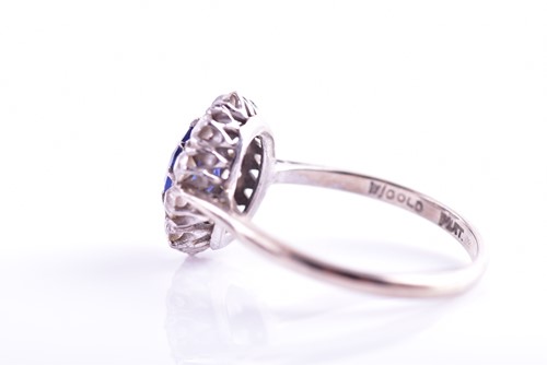 Lot 30 - A diamond and sapphire cluster ring, set with...