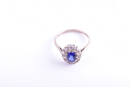 Lot 30 - A diamond and sapphire cluster ring, set with...
