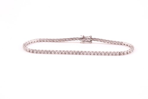Lot 170 - An 18ct white gold and diamond line bracelet,...