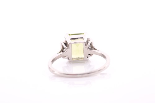 Lot 53 - A platinum, diamond, and peridot ring, set...