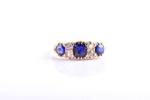 Lot 299 - An 18ct yellow gold, diamond, and sapphire...