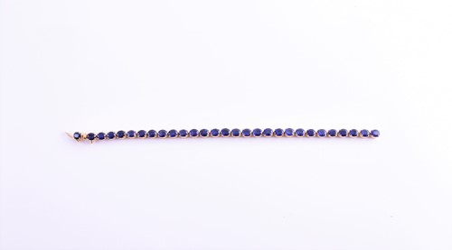 Lot 120 - A yellow metal and sapphire bracelet, set with...