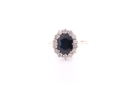 Lot 245 - A white metal and sapphire cluster ring, set...