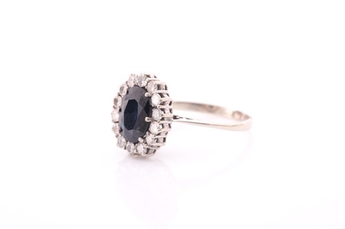 Lot 245 - A white metal and sapphire cluster ring, set...