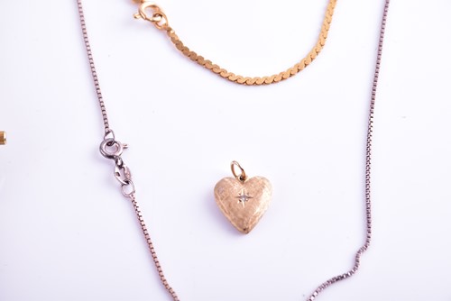 Lot 32 - A yellow metal heart-shaped pendant, together...