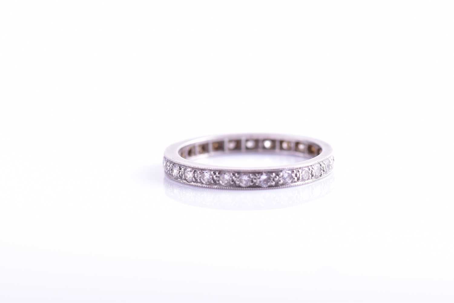 Lot 40 - A platinum and diamond eternity ring, set with...