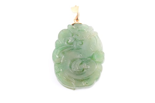 Lot 113 - A Chinese green jade pendant, with carved and...