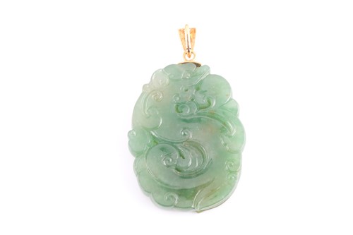 Lot 113 - A Chinese green jade pendant, with carved and...