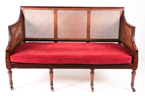 Lot 75 - A George IV three-seat Bergere settee with...