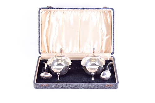 Lot 360 - A cased pair of 1930s silver sauce boats and...