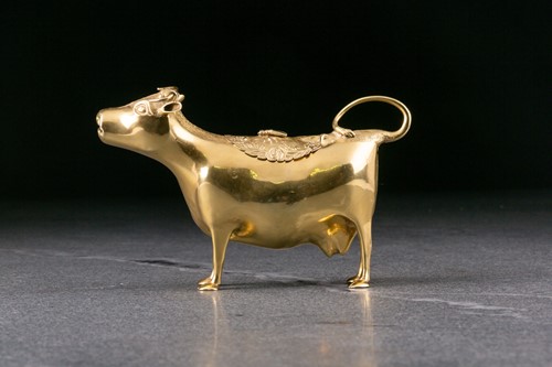 Lot 298 - A George III silver gilt cow creamer. London...