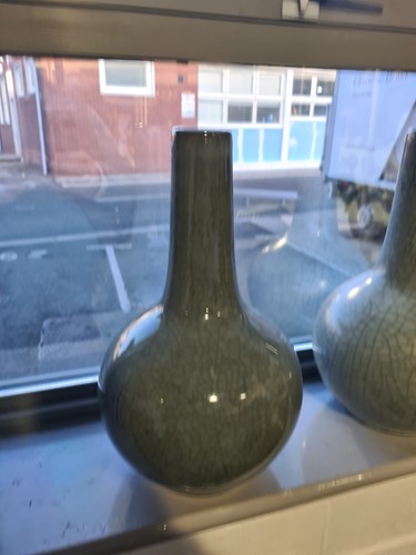 Lot 83 - A pair of Chinese celadon bottle vases, third...