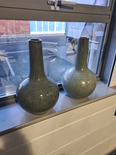 Lot 83 - A pair of Chinese celadon bottle vases, third...