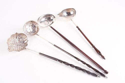 Lot 318 - A George III silver toddy ladle. London 1803...