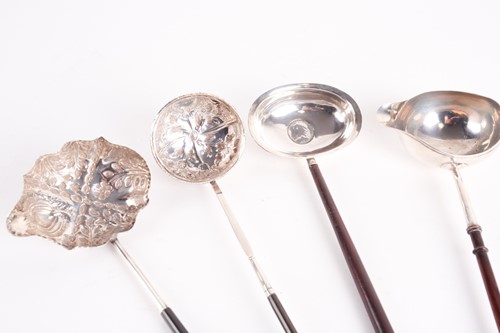 Lot 318 - A George III silver toddy ladle. London 1803...