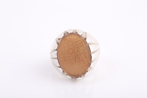Lot 252 - An Indo Persian white metal and hardstone ring,...
