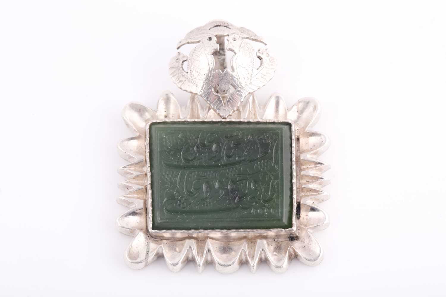 Lot 100 - An Indo Persian white metal and jade pendant,...