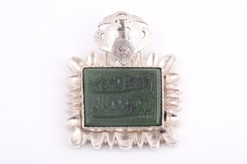 Lot 100 - An Indo Persian white metal and jade pendant,...