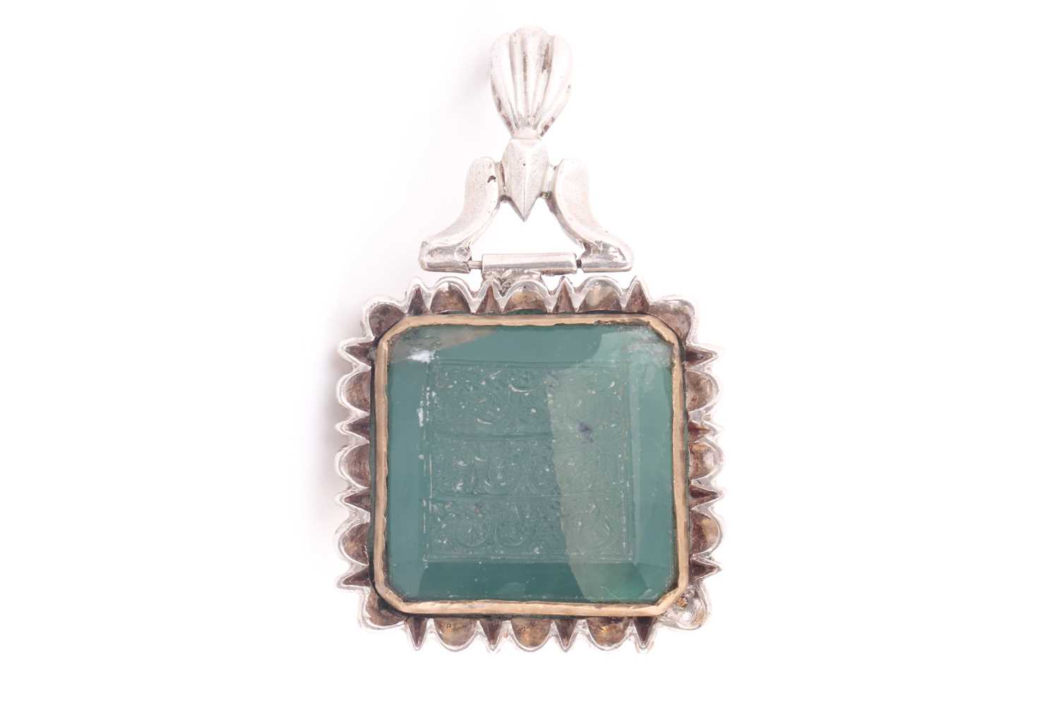 Lot 238 - A large Indo Persian green stone pendant in...