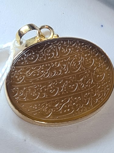 Lot 239 - An Indo Persian hardstone pendant in yellow...