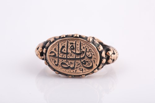 Lot 108 - A Persian gold coloured metal gentleman's ring,...