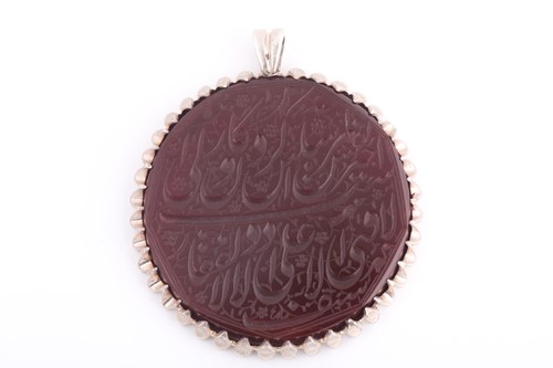 Lot 101 - An Indo Persian red hardstone pendant in...