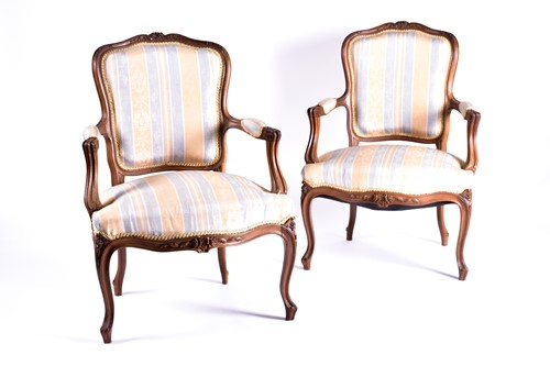 Lot 12 - A pair of Louis XV style walnut fauteuils,...