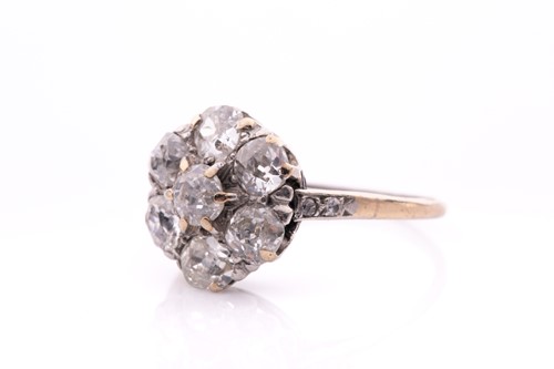 Lot 68 - A platinum and diamond daisy cluster ring, set...
